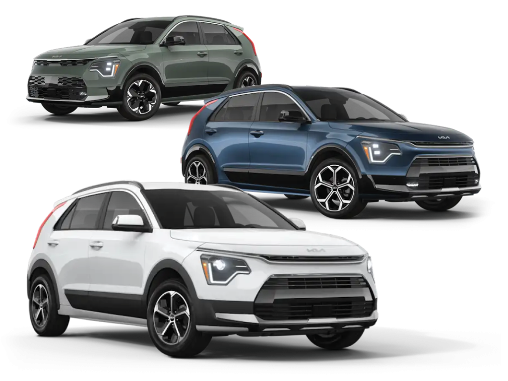 Three Kia Niro EVs in white, blue, and green are shown on a white background, angled to highlight their modern front-end design and LED headlights.