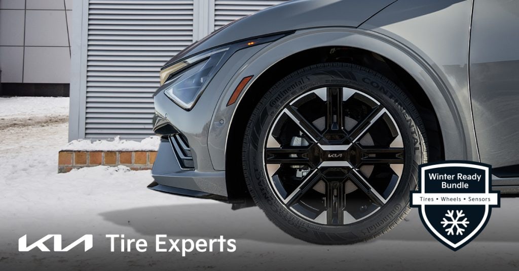 Close-up of a Continental winter tire mounted on a stylish black Kia wheel, with snow on the ground. Badge reads "Winter Ready Bundle – Tires, Wheels, Sensors."