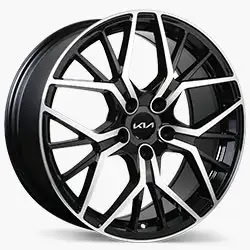 Two-tone black and silver Kia alloy wheel with an intricate, angular spoke design and Kia logo at the centre.