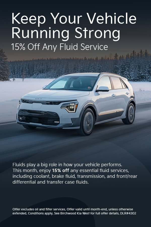 Winter auto service promotion featuring a white Kia SUV driving on a snowy road. Text reads “Keep Your Vehicle Running Strong – 15% Off Any Fluid Service,” including coolant, brake fluid, transmission, differential, and transfer case fluids. Limited-time offer with conditions noted.